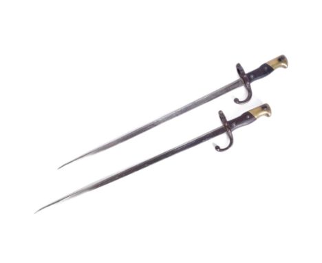 Two 19th Century French 1874 pattern Gras rifle bayonets. The hilt with brass pommel and wooden grips encasing the tang and s