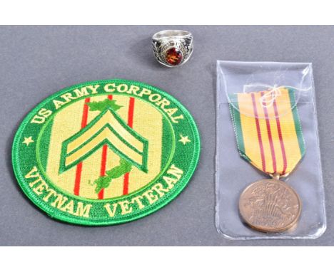 An original US United States Armed Forces Vietnam War Service medal along with a US Army Corporal patch and US Army Infantry 