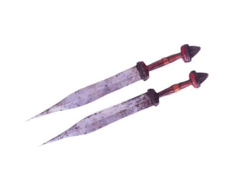 A pair of African Central Sahara (Chad) Tubu People tribal daggers. Exposed metal pommels, plaited leather grips and double e