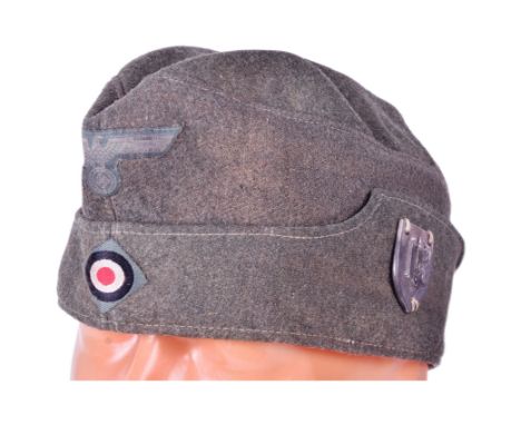 A WWII Second World War Third Reich Nazi German Army soldiers M43 overseas side cap with marksman badge. Embroidered roundel 
