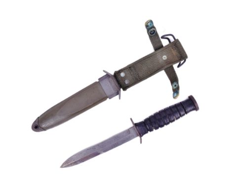 A WWII Second World War US United States M3 MKI fighting knife as issued to the Airborne Troops. Grooved leather handle and a