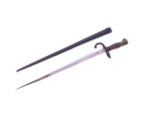 An original 19th Century French 1881 pattern Gras rifle bayonet. The hilt with brass pommel and wooden grips encasing the tan