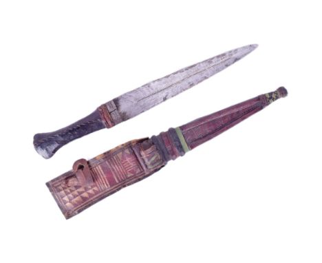 A small North African tribal Tuareg / Twareg dagger. Clad leather grip with a tapering stiletto blade incised with punchwork.