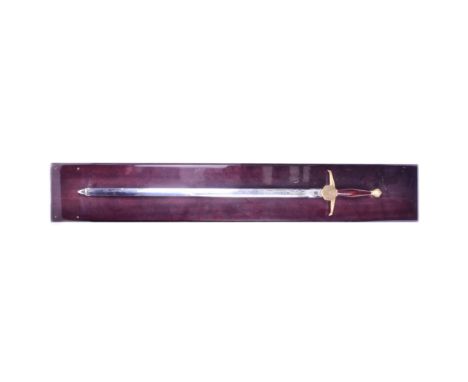 A Wilkinson made Queen Elizabeth II presentation sword. Gilt dome shaped pommel with a smooth brass grip and crossguard with 