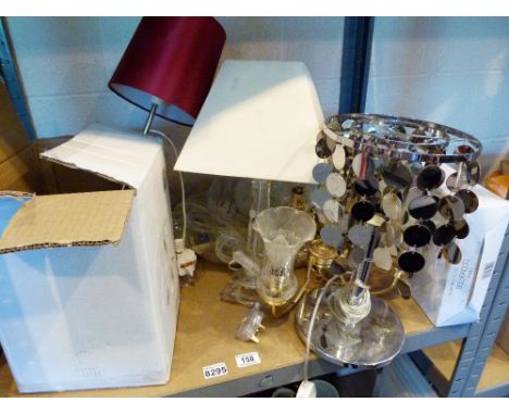 Shelf of mixed table lamps and a modern standard lamp