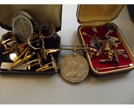 Collection of tie pins and cuff links together with a service medal