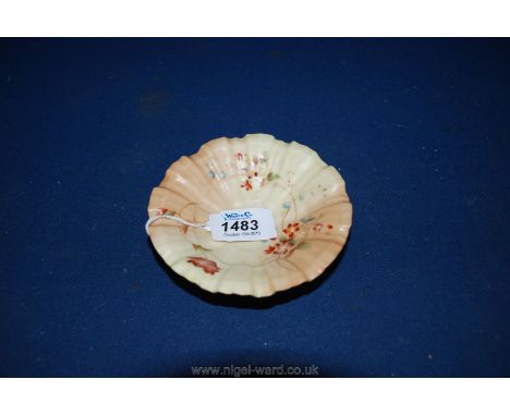 A Royal Worcester porcelain blush ivory circular fluted Dish, hand painted with summer flowers standing on three moulded shel