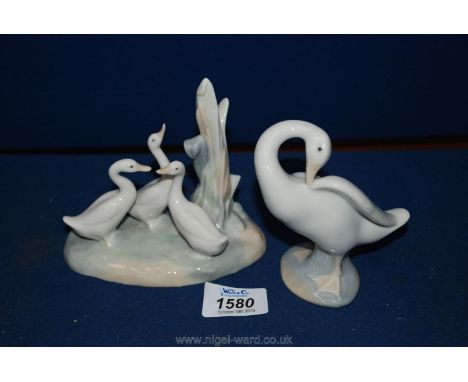 A Lladro duck preening together with a Nao group of ducks on realistic base.