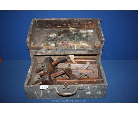 A wood workbox with five wood carpenters old tools.