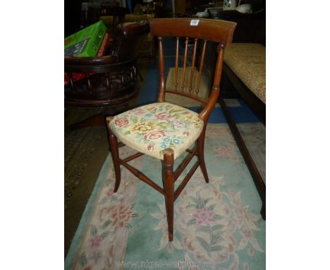 An Edwardian Mahogany framed bedroom chair having slender stickback detail, the seat upholstered with floral tapestry fabric.