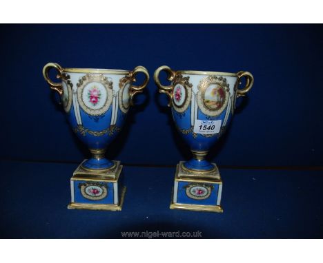 A pair of Noritake Vases in blue and gold, on plinth.