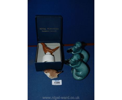 Two Poole pottery seals and a wren ornaments and boxed Royal Worcester flameproof pie funnel.