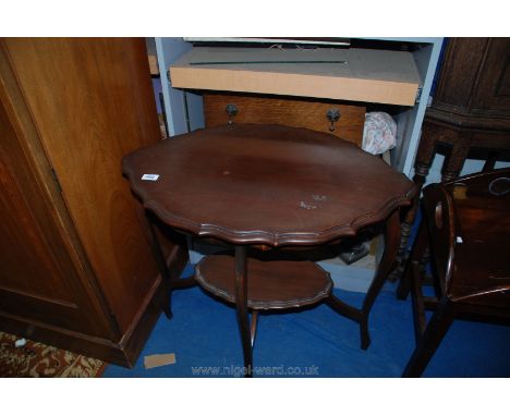 A lozenge shaped Edwardian Mahogany occasional Table having legs braced by a lower shelf of similar shape to the top, 29 1/4'