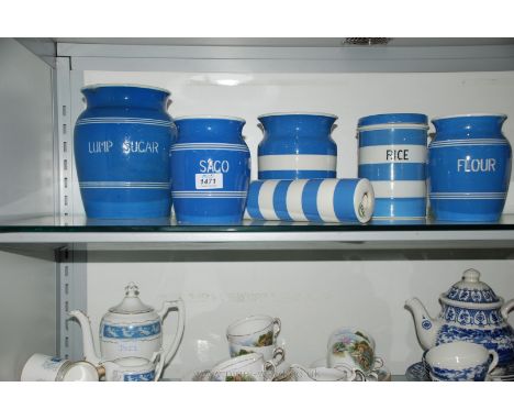 A quantity of Greens blue and white storage Jars and rolling pin.