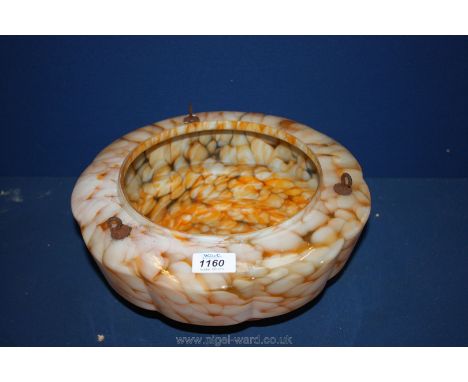A three tier stepped 1920's/1930's glass lamp shade in mottled orange and pink design.