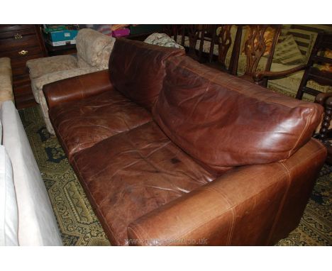 A three seater brown Leather upholstered Settee to match previous lot.