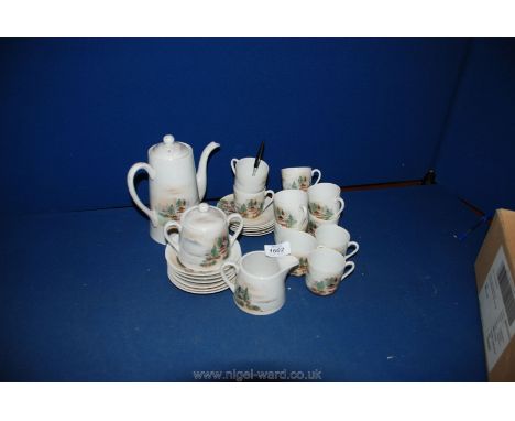 An Oriental coffee set including a coffee pot with lid, milk jug and sugar bowl, eleven saucers and eleven cans the cans havi