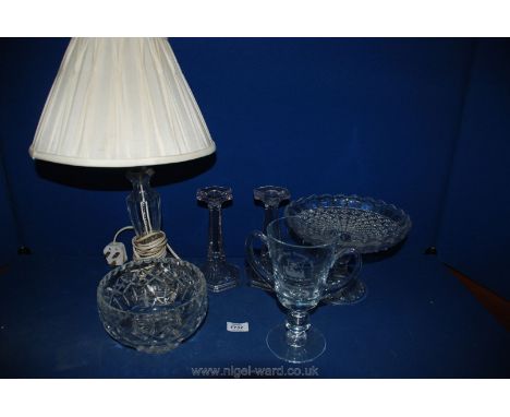 A cut glass lamp with shade, glass cake stand, bowl, trophy and pair of candlesticks.