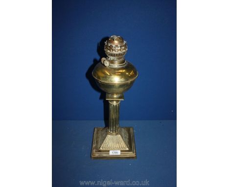 A brass oil lamp on pedestal.
