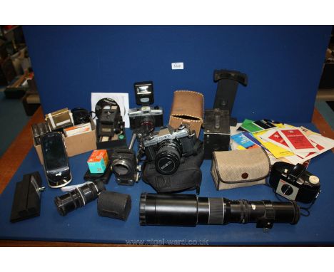 A quantity of photographic equipment including Minolta X300 camera, old Brownie cameras, lenses, filters, manuals etc