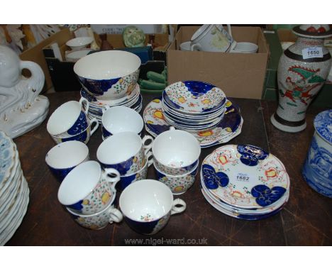 A Gaudy Welsh style tea set including twelve tea cups, sixteen saucers, two cake plates etc. some a/f.