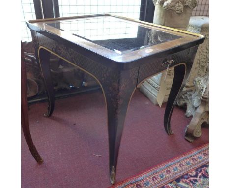 A pair of Drexel Heritage burr walnut and black lacquered lamp tables, with gilt floral decoration, smokey glass tops raised 