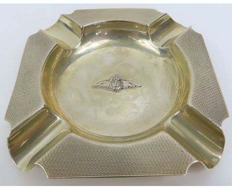 A silver ash tray, with applied RAF wings, engine turned, by Skinner &amp; Co, London 1930, approximately 10.5 cm across, 88 