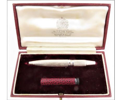 An Asprey's travelling pencil, with engine turned decoration, Birmingham, 1963, in fitted case with spare leads, and outer ca