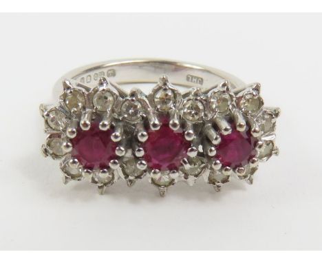 An 18ct white gold triple ruby and diamond cluster ring, the three round rubies with an approximate total weight of 0.55ct, s