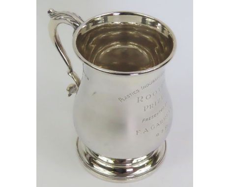 A silver Georgian style beer mug, by R&amp;D, Birmingham 1956, of baluster form and a leaf capped double scroll handle, inscr