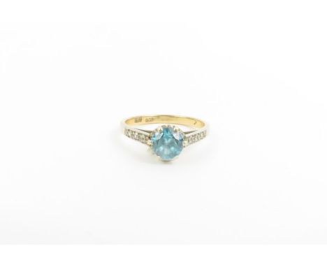 A blue zircon and diamond dress ring, the zircon approximately 6.4mm round, with three small round diamonds to each shoulder 