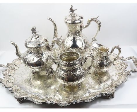 An Edwardian Victorian style silver tea and coffee service, by Barker Brothers, Birmingham 1902, of baluster form profusely e