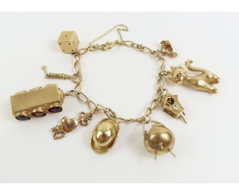 An elongated curb link bracelet, marked '9k', with various charms attached, to include a cuckoo clock, a cat and others, 17cm