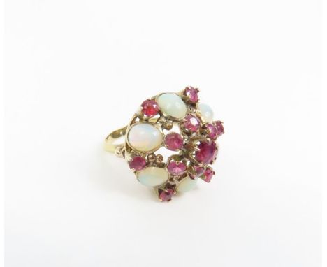 A contemporary white opal and ruby cluster ring, with decorative setting, marked '14k', finger size L, 4.2g gross