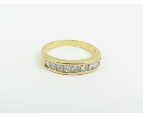 An 18ct gold princess cut diamond half eternity ring, the nine stones channel set, total diamond weight approximately 1ct, fi