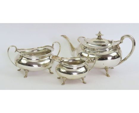 A matched three piece silver tea service, by H Atkin, Sheffield 1912 and 1913, the tea pot with insulated handle, approximate