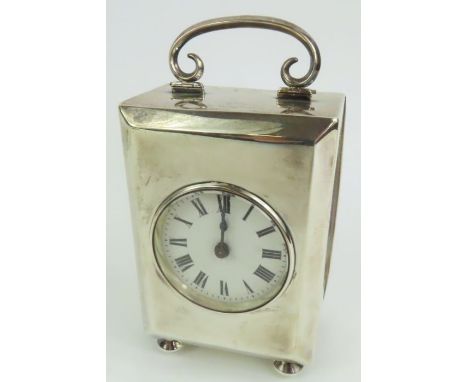 A silver carriage clock, by A &amp; J Zimmerman, Birmingham 1912, C scroll hinged handle, on bun feet, 14 cm high