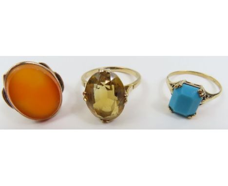 An oval carnelian set ring, marked '9ct', finger size H 1/2; an imitation turquoise set ring, marked '9ct', finger size N; an