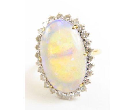 An opal and diamond cluster ring, the large oval cabochon cut opal approximately 17.7mm x 11mm x 4mm, approximately 4.42ct, s