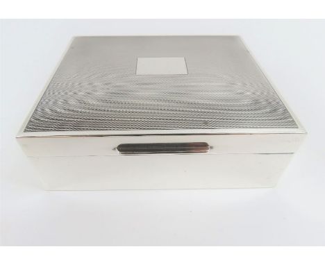 A silver cigarette box, with engine turned decoration 