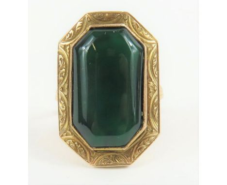 An 18th century ring, possibly a mourning ring, set with a large opaque hardstone with cantered corners, around the stone dec
