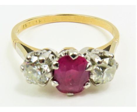 A ruby and diamond three stone ring, the central oval cut ruby approximately 5.8mm x 4.6mm x 2.9mm, 0.53ct, finger size M, te