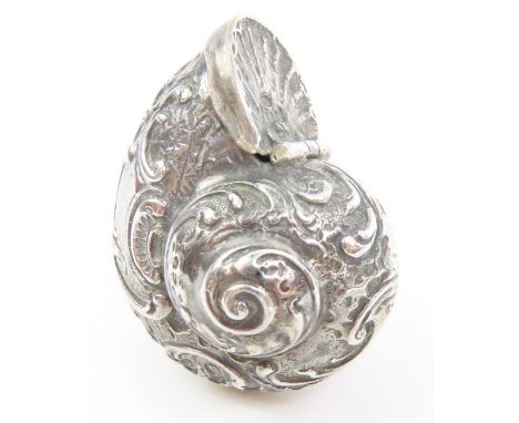 A silver snuff box in the form of a nautilus shell, London, 1977, heavily decorated in the Victorian style, 4cm across, 32.9g