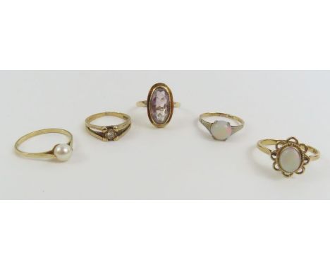 Four 9ct gold stone set rings, various sizes; together with a single stone opal ring, marked '9ct', finger size L,10g gross