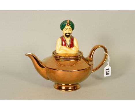A WADE NOVELTY 'THE GENIE TEAPOT', modelled as the genie's head as the lid and Aladdin's lamp as the teapot, height 21cm