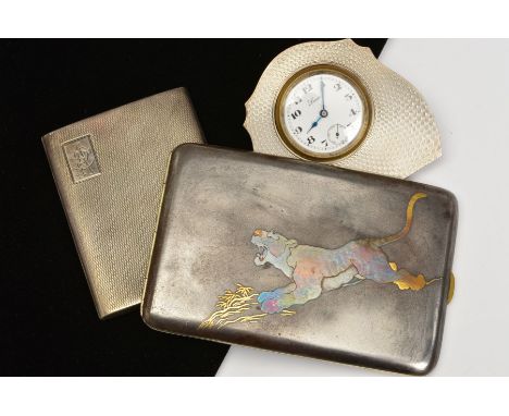 THREE SILVER WARE ITEMS, to include a rectangular shakudo cigarette case depicting a tiger, a 1920's silver engine turned cig