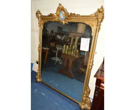 A MID 19TH CENTURY GILTWOOD OVERMANTEL MIRROR, of rectangular form, the pediment with swag and urn finials flanking an oval f