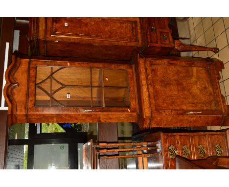 A REPRODUCTION WALNUT FLOORSTANDING CORNER CABINET, the upper section with single astragal glazed door, the base with cupboar