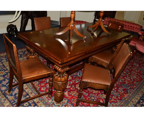 A REPRODUCTION OAK DRAW LEAF DINING TABLE OF RECTANGULAR FORM, chip carved edge to the frieze, on cup and cover carved legs w