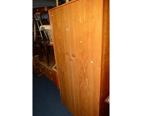 A 1960'S/70'S TEAK TWO PIECE BEDROOM SUITE, comprising of a double gentleman's wardrobe, width 92cm x depth 55cm x height 181